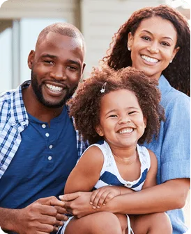 Smiling parents with their young daughter
