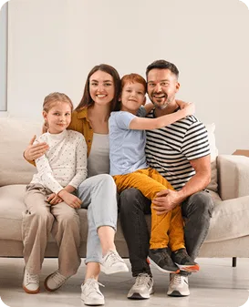 Family of four relaxing together on a sofa